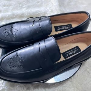 Male black leather penny loafers with brogue-detailed toe and clean classic finish