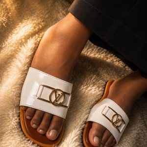 Female white slide sandal with gold buckle design